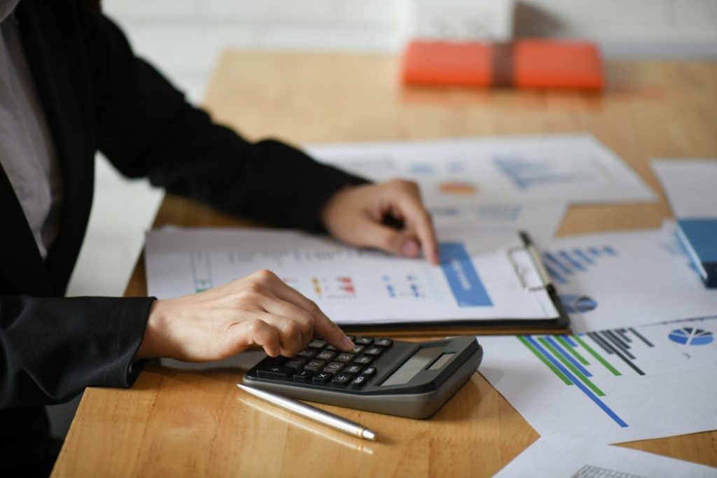 cropped shot of accounting staff are using calculators and graphing to pay annual taxes